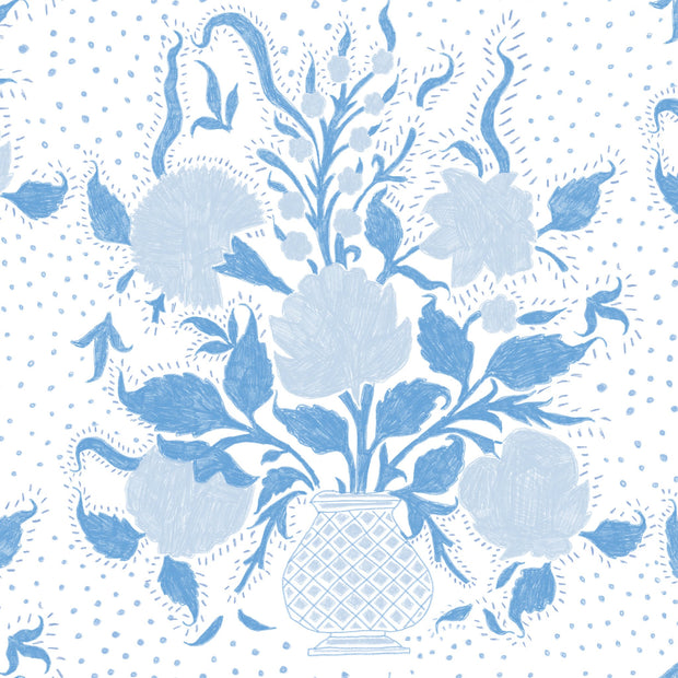 A blue fabric with a floral pattern featuring large blue flowers and smaller green leaves, with a repeat length of 23.69 inches by 13.