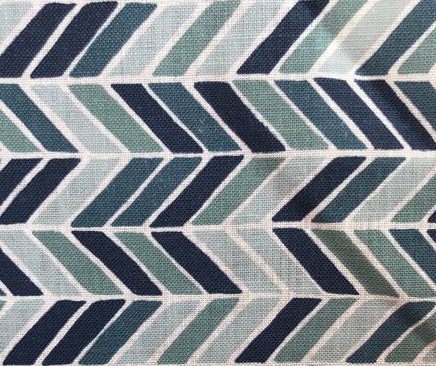 A fabric with a herringbone pattern in shades of blue and green.