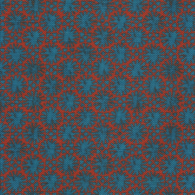 A fabric featuring a geometric pattern with red and blue colors on a blue background.
