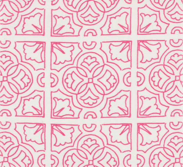 A fabric with a pink background and an Irish tile geometric pattern in fuchsia and white colors.