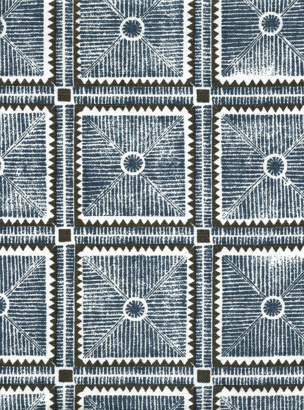 A fabric featuring a geometric pattern with abstract charcoal designs on a blue background, repeated over and over again.